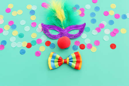 carnival, party and Purim celebration concept (jewish carnival holiday) over blue background