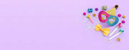 Holidays image of mardi gras masquarade sequins mask over purple background. view from above