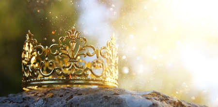 mysterious and magical photo of gold king crown in the woods over stone. Medieval period concept.の写真素材
