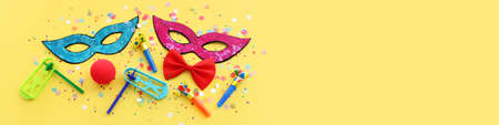 Purim celebration concept (jewish carnival holiday) over yellow backgroundの写真素材