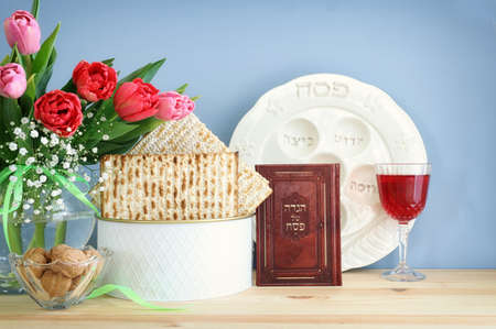 Pesah celebration concept (jewish Passover holiday). Traditional pesah plate text in hebrew: Passover, horseradish, celery, egg, bone, maror, sweet dates jamの写真素材