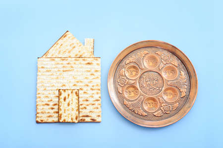 Pesah celebration concept (jewish Passover holiday). Traditional pesakh plate text in hebrew: horseradish, celery, egg, bone, maror, charosetの写真素材