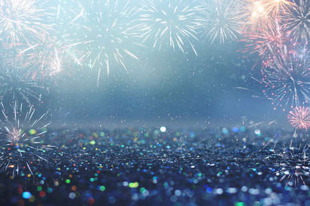 abstract gold, black and blue glitter background with fireworks. christmas eve, 4th of july holiday...