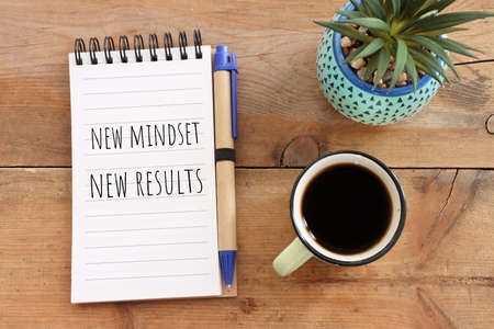 concept image with new mindset new results text. top view of office tableの写真素材