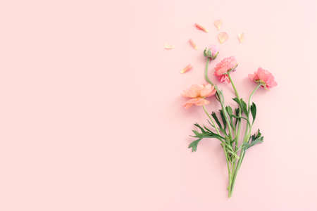 Top view image of pink flowers composition over pastel backgroundの写真素材