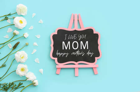 mother's day concept with white flowers over blue pastel backgroundの写真素材