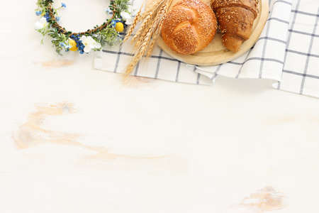 Bread and buns over wooden white background.の写真素材