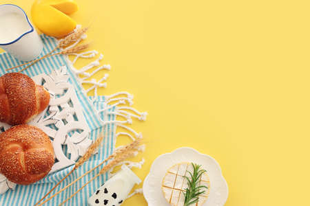 top view photo of dairy products over yellow background. Symbols of jewish holiday - Shavuotの写真素材