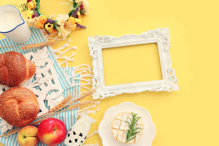 top view photo of dairy products over yellow background. Symbols of jewish holiday - Shavuotの写真素材