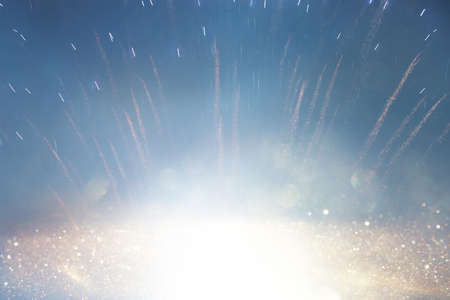 background of abstract gold, silver and blue glitter lights with fireworks. defocused