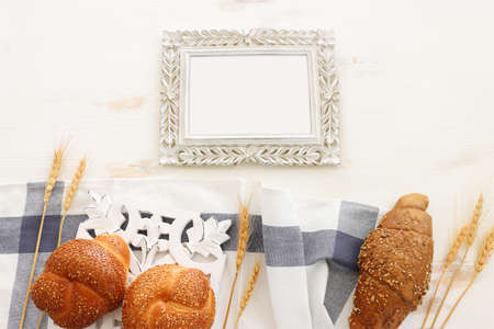 Bread and buns over wooden white background.の写真素材