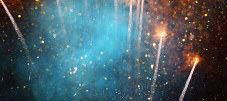 background of abstract gold, black and blue glitter lights with fireworks. defocusedの写真素材