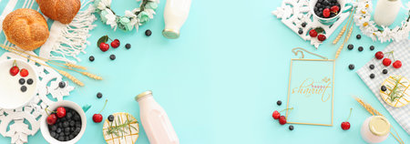 top view photo of dairy products and fruits over pastel blue background. Symbols of jewish holiday - Shavuotの写真素材