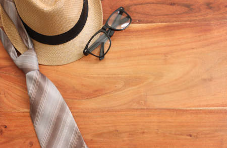 Father's day concept with fedora hat and necktie over wooden background. top view, flat layの写真素材