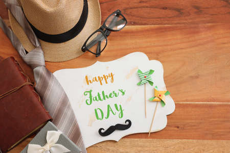 Father's day concept with fedora hat and necktie over wooden background. top view, flat layの写真素材