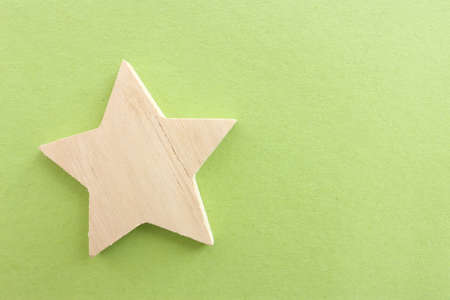 Top view image of wooden star over textured green backgroundの写真素材