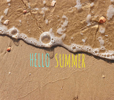 The word summer written in sea sand. Warm sunset time, vacation and enjoymentの写真素材