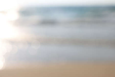 background of blurred beach and sea waves with bokeh lights