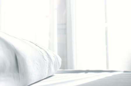 close up photo of pillow and sheets at morning sunrise in the bedroom. vintage filteredの写真素材