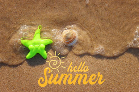 Top view image of sandy summer beach and plastic star fish