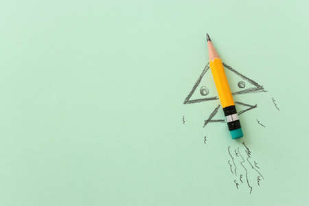 Pencil and rocket sketch over textured paper, concept of back to school, creativity and successの写真素材