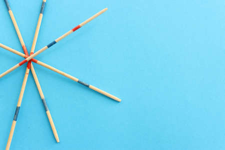 Mikado game over blue background. Wooden sticks that create a graphic image and a geometric frameの写真素材
