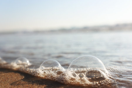 Sea waves and warm sunset light, calm and relaxing sandy beachの写真素材