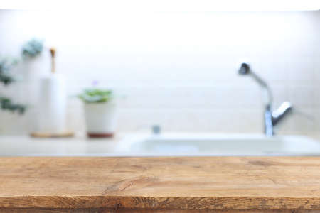 empty table board and defocused modern kitchen background. product display conceptの写真素材