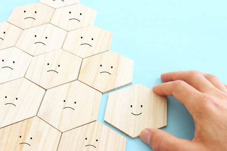 Concept image of satisfaction level. wooden cubes with emotions