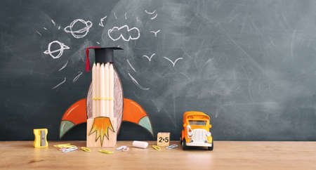 education. Back to school concept over wooden table and blackboard backgroundの写真素材