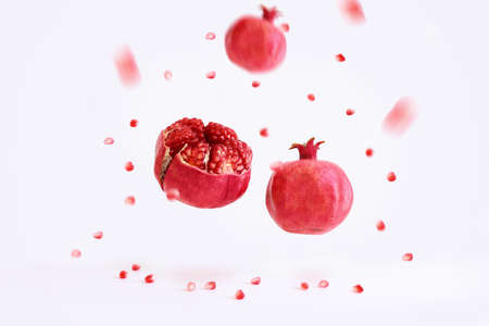 Rosh hashanah (jewish New Year holiday) concept. Pomegranate traditional symbol over white backgroundの写真素材
