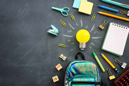 Education concept image. Creative idea and innovation. light bulb metaphor over blackboard...