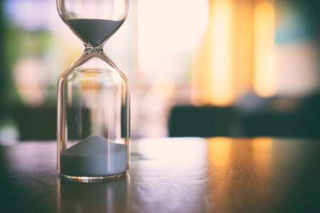 Vintage hourglass clock over table