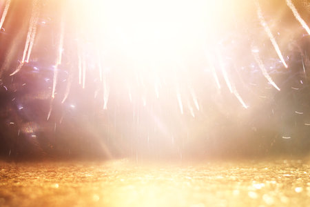 abstract black and gold glitter background with fireworks. christmas eve, 4th of july holiday...
