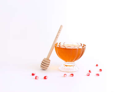 Rosh hashanah (jewish New Year holiday) concept. Honey traditional symbol over white backgroundの写真素材