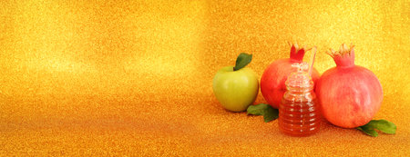 Rosh hashanah (jewish New Year holiday) concept. Taditional symbols over gold glitter backgroundの写真素材