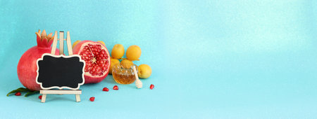 Rosh hashanah (jewish New Year holiday) concept. Taditional symbols over blue glitter backgroundの写真素材