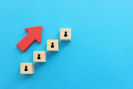 Red arrow and cubes with people icons. Leadership and growth conceptの写真素材