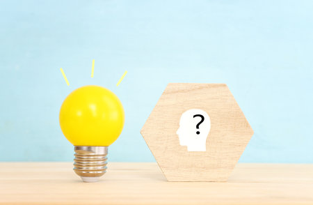 Education and human resource concept image. Creative idea and innovation. light bulb metaphor over blue background, wooden cubes and people iconsの写真素材