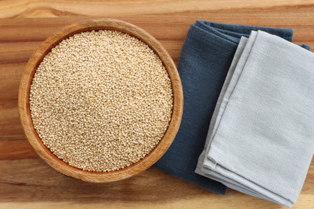 Top view image of quinoa in wooden plate on tableの写真素材