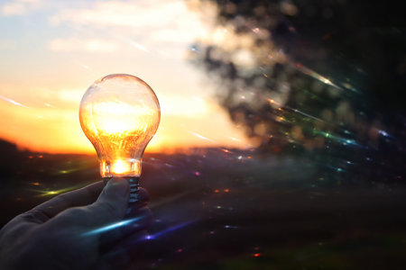 energy and business concept image. Creative idea and innovation. light bulb metaphor in front of the sunの写真素材