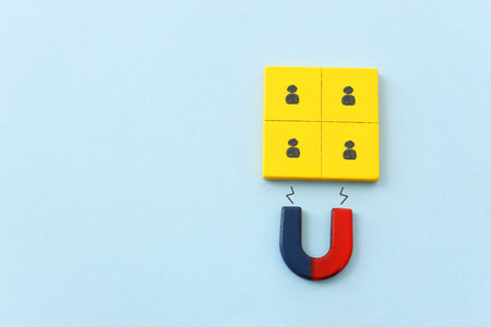 Concept image of a magnet attracting a group of people. metaphor of media influence and human...