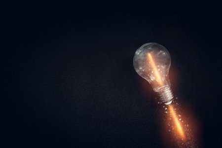 Light bulb over dark black background. Concept of creativity and innovation