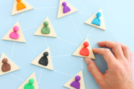 Colorful figures connected over blue background, concept of human resources and collaboration