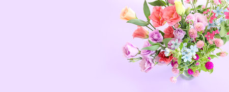 Top view image of pink and purple flowers composition over pastel backgroundの写真素材