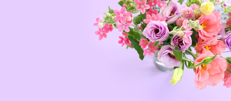 Top view image of pink and purple flowers composition over pastel background