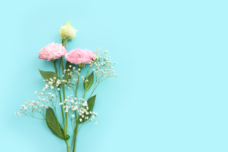 Top view image of delicate lisianthus flowers over pastel blue backgroundの写真素材