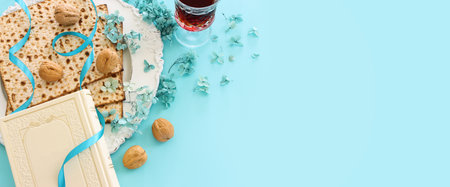 Pesah celebration concept (jewish Passover holiday) over pastel blue background