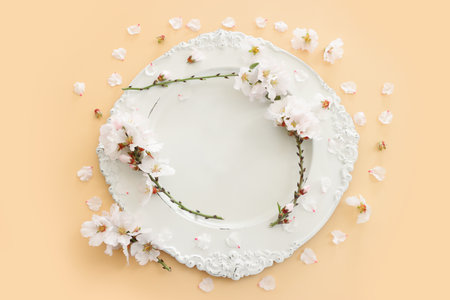Top view of vintage white empty plate over spring cherry tree flowers. Flat layの写真素材