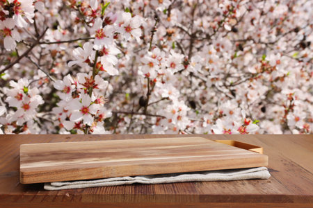 wooden table in front of spring blossom tree landscape. Product display and presentationの写真素材
